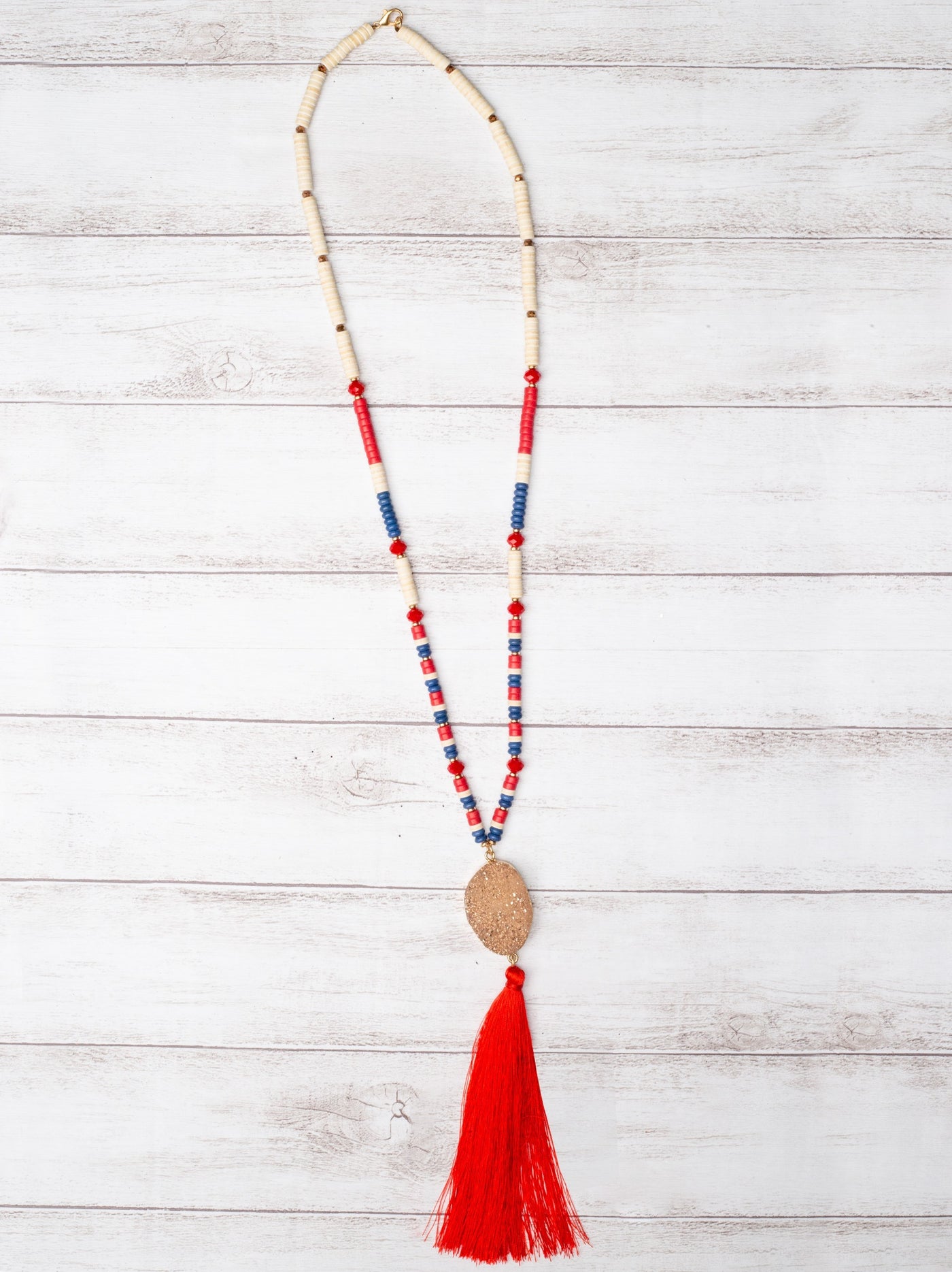 GOOD TIMES AND TAN LINES ROSE GOLD DRUZY STONE PENDANT WITH RED TASSEL ON A MIXED FLAT BEADED NECKLACE