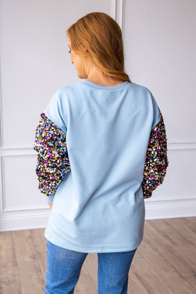 Nutcrackers on Blue Sweatshirt with Sequin Sleeves