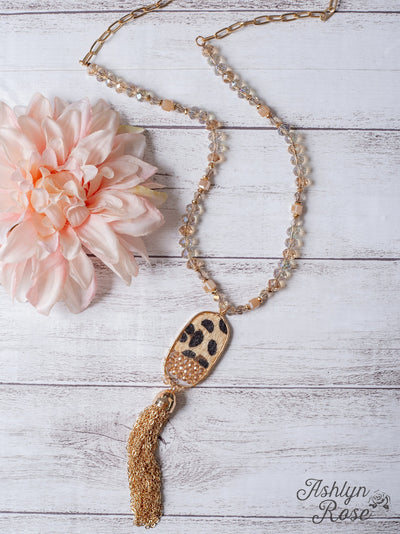 ALL THE DRAMA OVAL LEOPARD TASSEL GOLD PENDANT ON A IRIDESCENT CRYSTAL BEADED GOLD LINKED CHAIN NECKLACE