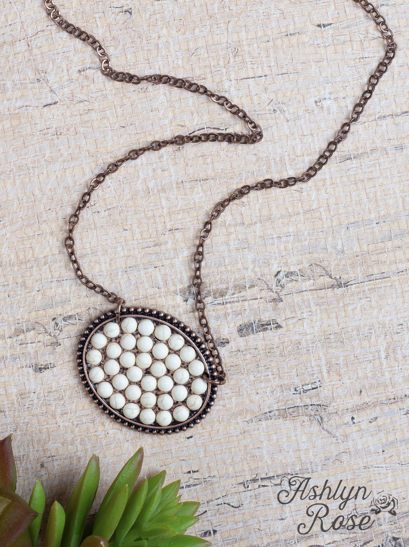 Bumpily Bamboozled Bronze Necklace With A Cream Pendant